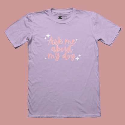 Purple T-shirt printed with pastel pink lettering saying "ask me about my dog"